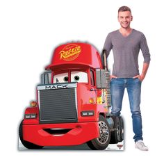 a man standing next to a red truck with the character mack on it's side