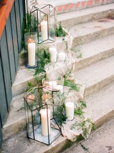 candles are lined up on the steps outside