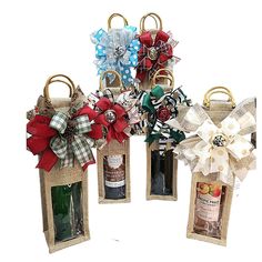 four wine bags with bows and bottles in them