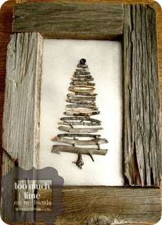 a small wooden christmas tree in a frame