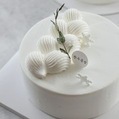 a cake with white frosting and small flowers on top