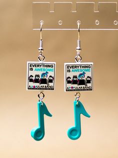 the earrings are designed to look like musical notes and have been hung from hooks with clippings