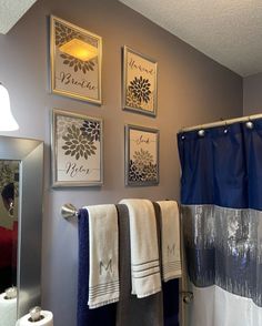 a bathroom with blue and white towels hanging on the wall