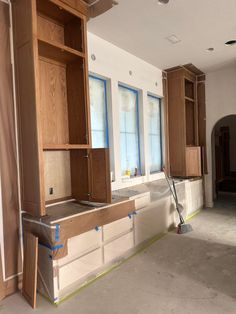 an empty room with cabinets and tools in the process of remodeling it