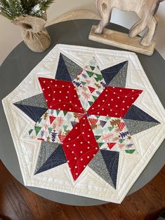 a quilted table topper with a red, white and blue star on it