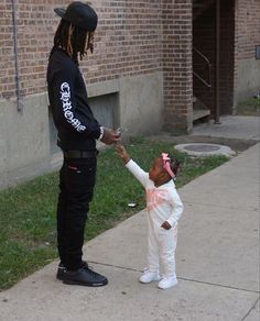 a young child is handing something to an officer