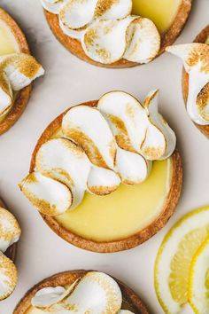 lemon tarts with meringue and whipped cream on top