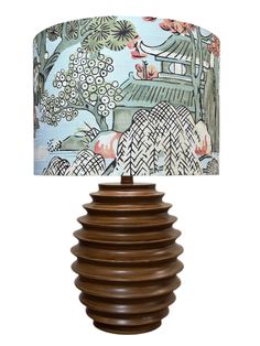 a lamp that is sitting on top of a wooden base with a blue and white lampshade