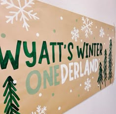 a sign that says wyatt's winter onederland with snowflakes on it