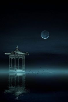 a gazebo in the middle of water at night with a full moon behind it