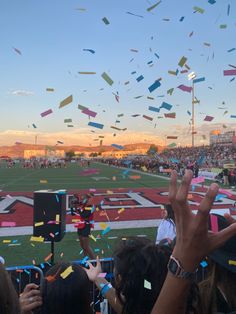 confetti is thrown in the air at a football game