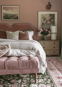 a bedroom with pink and white decor on the walls, rugs and bedding