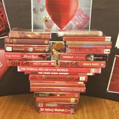 a stack of books sitting on top of a wooden table