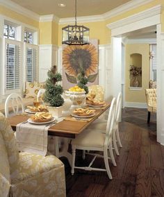 the dining room table is set with sunflowers and dishes on it's centerpiece