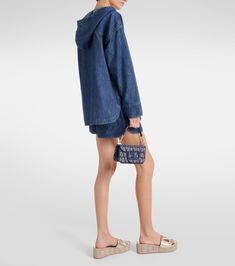 Denim chambray hoodie in blue - Valentino | Mytheresa Denim Blue Hoodie With Pockets, Hooded Dark Wash Cotton Denim Jacket, Spring Denim Washed Hoodie, Denim Hoodie With Pockets In Medium Wash, Spring Washed Denim Hoodie, Denim Hoodie With Pockets, Denim Hooded Hoodie With Pockets, Spring Denim Hooded Hoodie, Hooded Denim Hoodie With Pockets