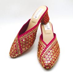 Check out our new collection of designer wedding shoes which we offer for you. These beautiful shoes are pink with gold sequins work on embroidered all around the shoe and round front shaped. These are extremely comfortable wedding shoes with a low heel these are comfortable to wear for long hours. These are perfect for your wedding or a formal event. These bridal shoes offer a heel size of 3 Inches. Don't miss out on these beauties! See our page for more of our collection! We ship out in a timely matter, wrapped in care for a safe secure trip to your location. Thank you for supporting our small business! Shipped from USA. Sizes available US 6,7,8,9,10. Indian Wedding Heels, Gold Slip-on Heels For Wedding, Traditional High Heel Festive Heels, Traditional High Heels For Festive Occasions, Festive Wedding Shoes With Round Toe For Party, Embroidered Pointed Toe Wedding Shoes For Party, Formal Embroidered High Heel Wedding Shoes, Summer Party Slip-on Wedding Shoes, Festive Closed Toe Wedding Shoes For Party