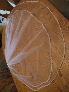 the wedding veil is laying on top of the table