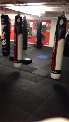 an empty boxing gym with punching bags