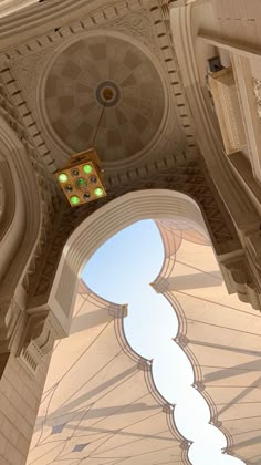 the inside of a building with a clock on it's face and an arch in the ceiling