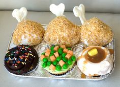 an assortment of pastries on a tray with marshmallows, carrots and sprinkles