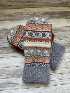 Upcycled wool sweater mittens. These cozy mittens are perfect for cold winter days. This pair is made from four different sweaters I washed in hot water to felt.  The inside is lined with cozy warm fleece.  This pair would fit most women's  hands. Measurement are 9.5 inches top to bottom and 4.5 inches wide.  Each pair is a one of a kind creation  Hand wash and lay flat to dry Looking for a certain color?  Send me a note and I will create a pair for you! Mittens were made from a pattern from  ww Sweater Mittens, Recycled Sweaters, Wool Mittens, Winter Days, Winter Day, Wool Sweater, Mitten Gloves, Cold Winter, In Hot