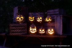 pumpkins lit up in the shape of jack - o'- lanterns