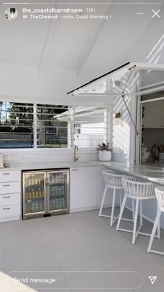 an image of a kitchen setting with white furniture