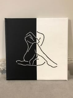 a black and white canvas with a drawing of a woman's legs on it