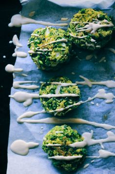 broccoli florets are drizzled with white icing on blue paper