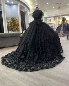 Make a bold and unforgettable statement with the Black Ball Gown Off the Shoulder Quinceanera Dress. This dress is crafted from luxurious tulle fabric and is adorned with intricate appliqued details that add texture and depth. A stunning bow knot at the back gives the dress a playful yet elegant finish, perfect for making a statement at your quinceanera. The off-the-shoulder neckline exudes sophistication, beautifully framing your shoulders and decolletage. The chapel train adds a touch of grand Ball Gown Prom Dresses, Gown Prom Dresses, Black Quinceanera Dresses, Black Ball Gown, Dress Ball Gown, Red Carpet Gowns, Black Strapless Dress, Wedding Dress Fabrics, Gown Prom