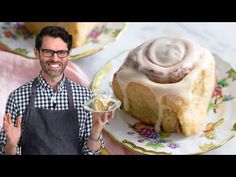 a man holding a plate with a cake on it