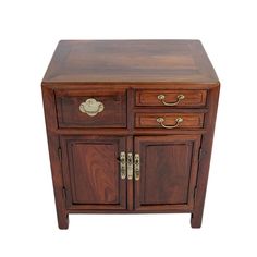 a small wooden cabinet with two drawers and brass pulls on the front door, against a white background