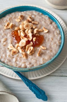 a bowl of oatmeal with nuts on top