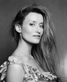 a woman with long hair posing for a photo