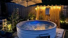 an outdoor hot tub with lights around it