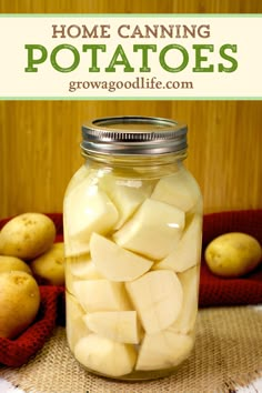 a mason jar filled with potatoes sitting on top of a table next to other potatoes