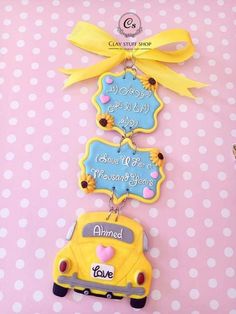 some cookies that are on top of a pink and white polka dot table with yellow ribbon