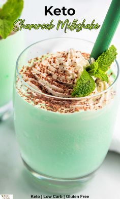 two glasses filled with green drinks and topped with whipped cream