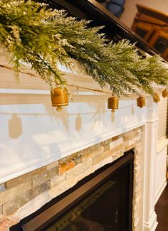 a christmas tree is hanging over the fireplace