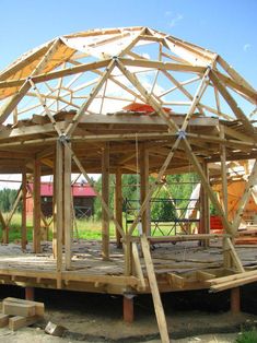 a large wooden structure sitting on top of a field