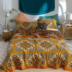 a bed with yellow and blue bedspread in a room