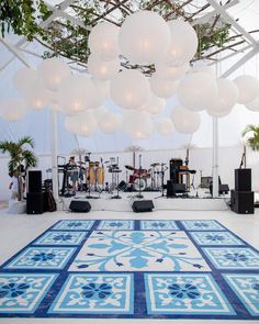 a large blue and white area rug with lights hanging from it's ceiling in an indoor venue