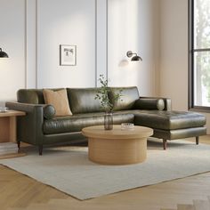 a living room with a couch, coffee table and lamp on the wall next to it