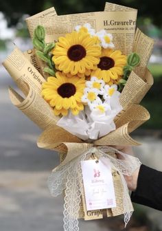 a bouquet of sunflowers wrapped in newspaper