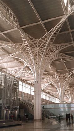 people are walking through an airport terminal