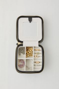 an open jewelry box with rings and bracelets