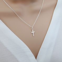 Small cross necklace, sterling silver cross necklace women, cross pendant, religious catholic jewelry, tiny cross necklace Our small cross necklace is super dainty & minimalistic - perfect for layering with other necklaces. Would make the perfect meaningful gift for yourself or someone special.  Explore our gorgeous collection of dainty and personalised necklaces and bracelets. Lovingly handcrafted for you, our beautiful, collectable pieces combine minimalism and personalisation.  https://www.et Small Silver Cross Necklace, Delicate Sterling Silver Cross Pendant Necklace, Minimalist Cross Pendant Charm Necklace, Sterling Silver Cross Pendant Charm Necklace, Dainty Sterling Silver Cross Pendant Charm Necklace, Simple Sterling Silver Cross Pendant Necklace, Minimalist Silver Cross Pendant Charm Necklace, Minimalist Silver Charm Necklace With Cross Pendant, Minimalist Sterling Silver Crucifix Necklace