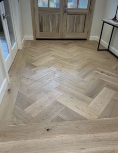 an empty room with wooden floors and doors