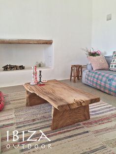 a living room filled with furniture and a wooden table on top of a carpeted floor