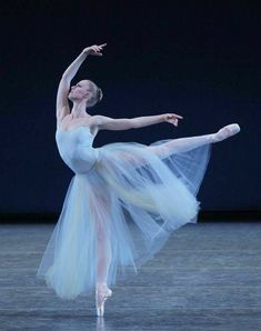 the ballerina is wearing a blue tulle skirt